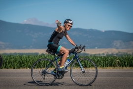 A woman rides a bike outside 